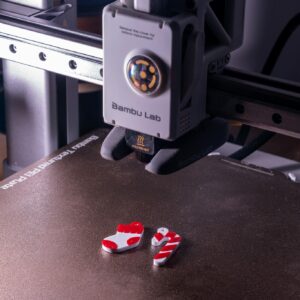 Close-up of a 3D printer creating red and white plastic objects.