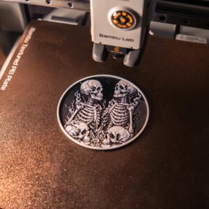 Close-up of an intricate 3D printed skeleton artwork being created on a 3D printer, showcasing digital craftsmanship.